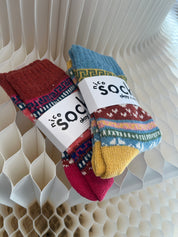 Colorful socks with a brand label on a textured surface