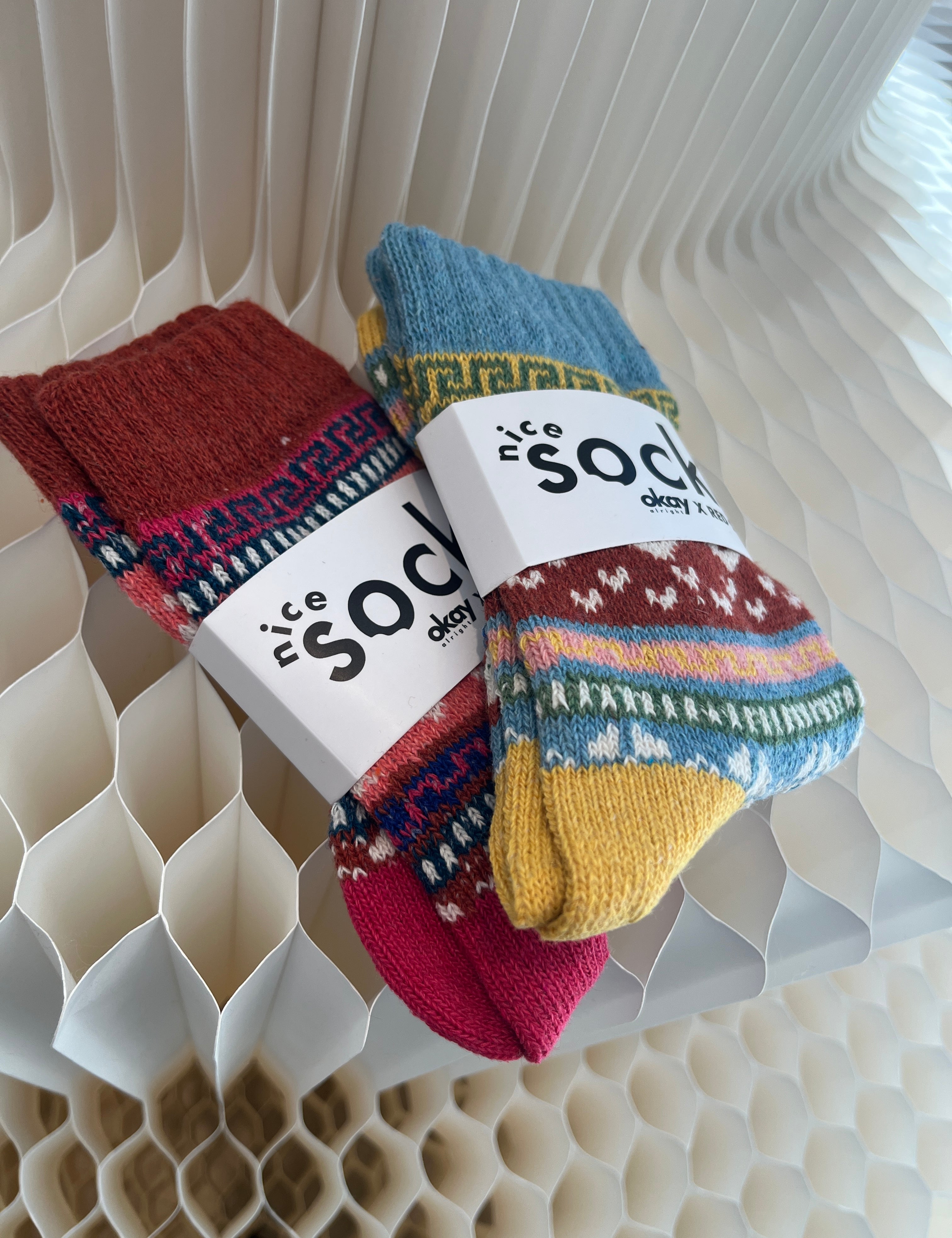 Colorful socks with a brand label on a textured surface