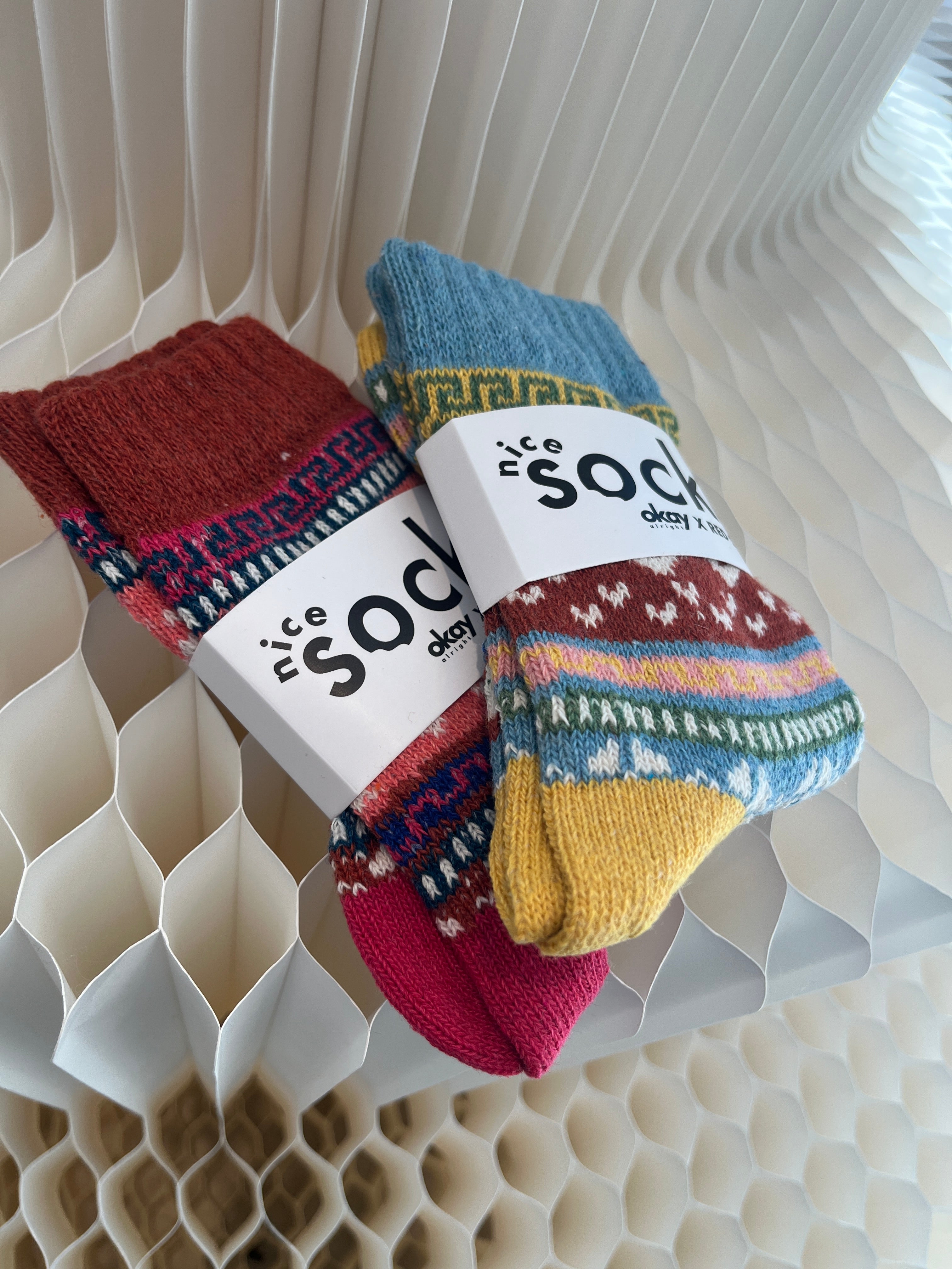 Colorful socks with a brand label on a textured surface